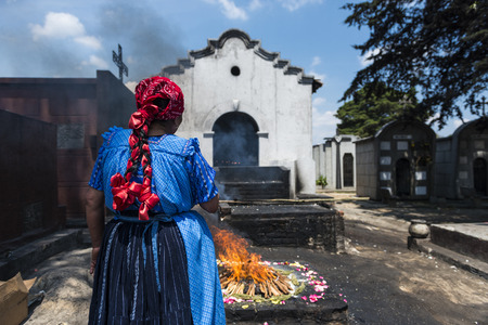 Chichicastenango, Guatemala - April 24, 2014: Maya woman performing a traditional mayan ritual in the cemetery of the town of Chichicastenango, in Guatemalaのeditorial素材