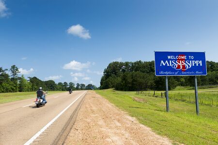 Two motorcycles passing by the Mississippi State welcome sign along the US Highway 61 in the USA; Concept for travel in America and Road Trip in Americaの写真素材