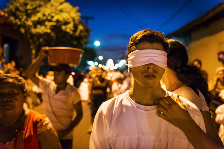 Leon, Nicaragua - April 15, 2014: Blindfolded man in a procession in the streets of the city of Leon in Nicaragua during the Easter celebrationsのeditorial素材