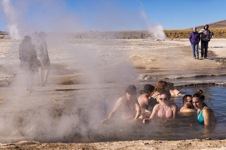Geysers del Tatio, Chile - November 24, 2013: People bathing in a hot spring pool at he Geysers del Tatio field in the Atacama Desert, Northern Chileのeditorial素材