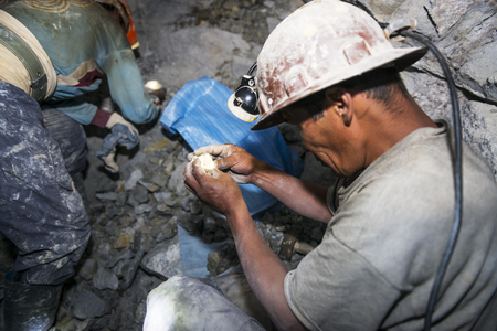 Potosi, Bolivia - November 29, 2013: Two miners looking for silver in the silver mine of the Cerro...