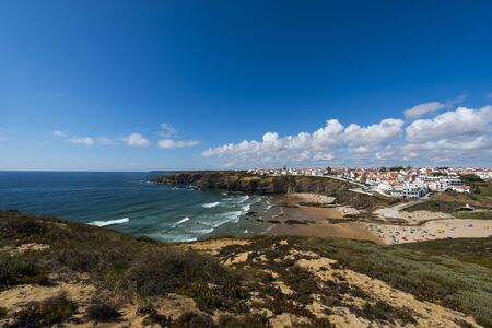 The fishing village of Zambujeira do Mar and its beach in the Vincentine Coast, Alentejo, Portugal; Concept for travel in Portugal and summer vacationsの写真素材
