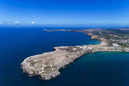 Aerial view of the Sagres Sagres Point with the Saint Vincent Cape (Cabo de Sao Vincente) on the background, in Algarve, Portugalのeditorial素材