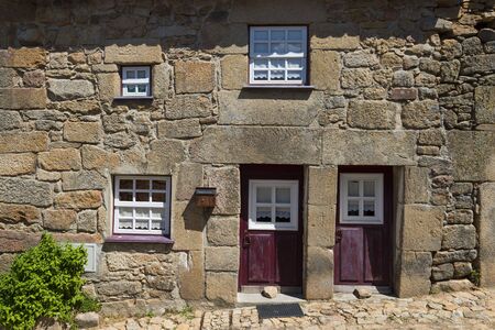 Detail of the facade of a traditional house made of stone in the historic village of Castelo Mendo, in Portugal; Concept for travel in Portugalの写真素材