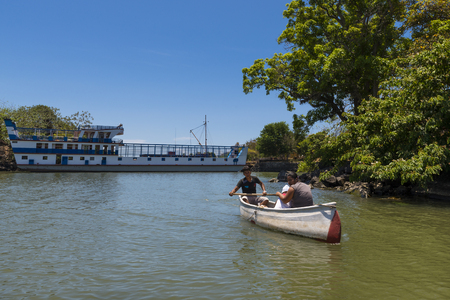 Islets of Granada, Nicaragua - April 3, 2014: Couple with a young baby in a canoe in the Islets of Granada in the Lake Nicaragua, Nicaraguaのeditorial素材