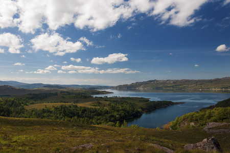 Beatiful and serene landscape of a lake in the Highlands of Scotland, United Kingdom; Concept for travel in Scotlandの写真素材