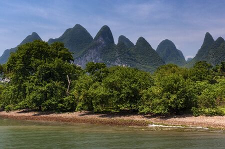 View of the Li River with the tall limestone peaks on the background near Yangshuo, China, Asia;...