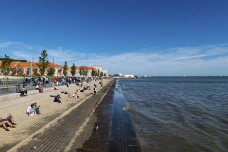 Lisbon, Portugal - October 22, 2017: Tourists enjoying a sunny day in the banks of the Tagus River...