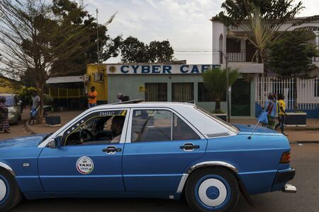 Bissau, Republic of Guinea-Bissau - January 28, 2018: Street scene in the city of Bissau with a taxi...
