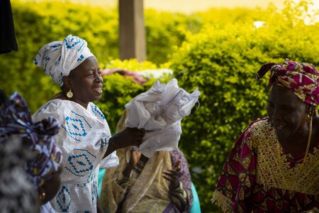 Bissau, Republic of Guinea-Bissau - January 31, 2018: Group of women singing and dancing traditional songs at a community meeting in the city of Bissau, Guinea-Bissau, West Africaのeditorial素材