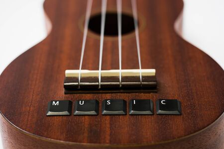 ukulele on isolated background with lettering music on white isolated background, bottom view