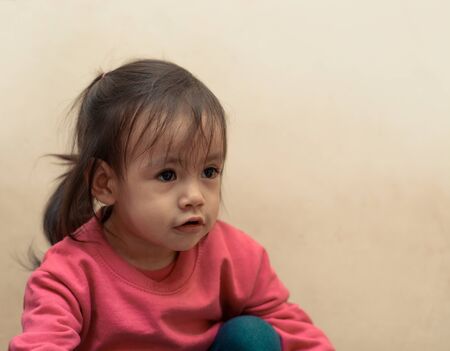 Beautiful girl looking up, space to insert text or designの写真素材