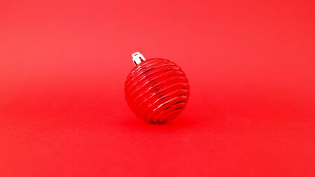 Red christmas ball and a red backgroundの写真素材