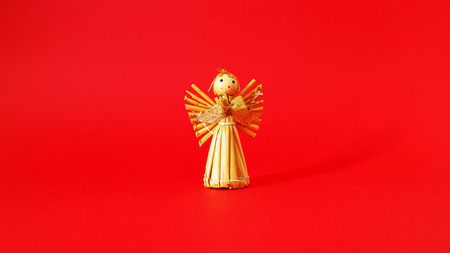 Straw angel with a red backgroundの写真素材