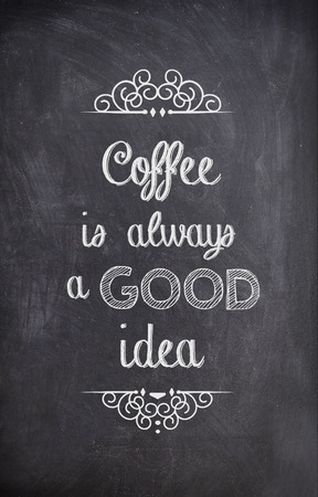 Coffee Quote written with chalk on a black boardの写真素材