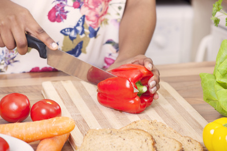Young lady chopping vegetablesの写真素材