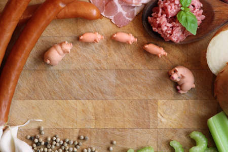 Miniature pigs surrounded by pork meatの写真素材