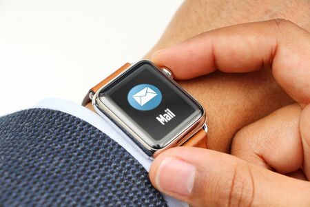 Business' man checking e-mails with a smart watch appの写真素材