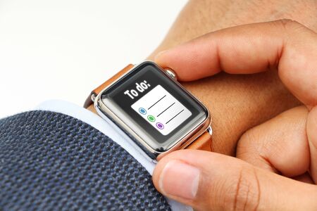 Business man making a "To do" list with a smart watch's appの写真素材