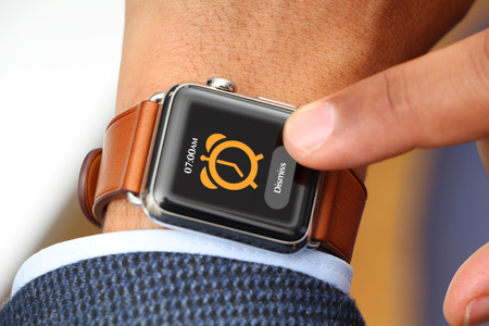 Interracial businessman using a smartwatchの写真素材