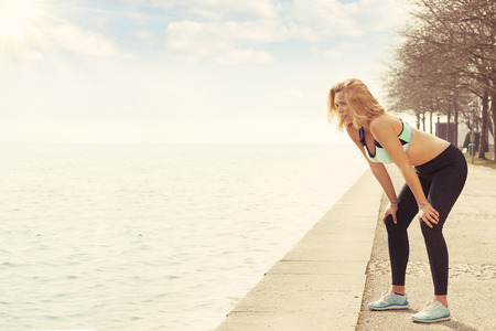 Running fitness woman exhausted after runの写真素材