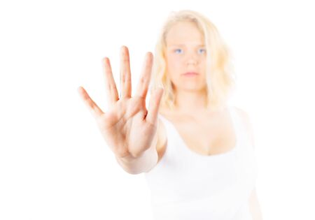 Woman signing STOP with her handの写真素材