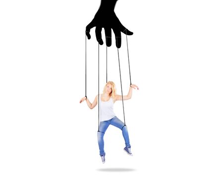 Girl being held by strings as a puppetの写真素材