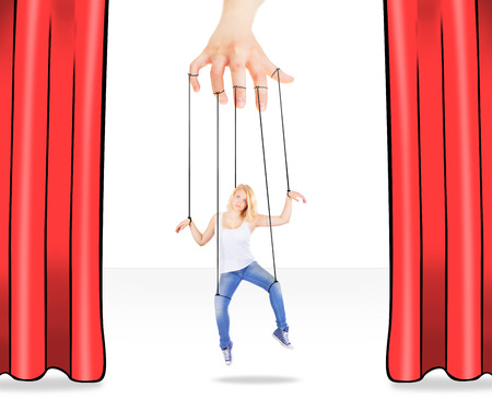 Girl being held by strings as a puppetの写真素材