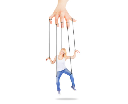 Girl being held by strings as a puppetの写真素材