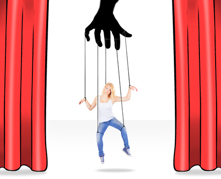 Girl being held by strings as a puppetの写真素材