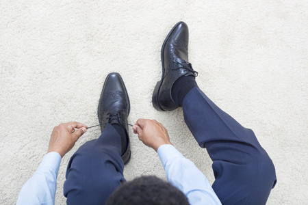 Man tying shoelaces shoes. Getting ready conceptual ideaの写真素材