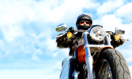 Biker On the road over skyの写真素材