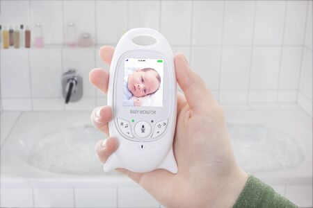 Parent won't have time for a bath as baby is awake on baby monitorの写真素材