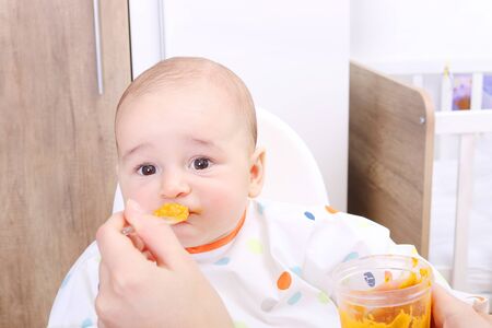 Baby being fed solidsの写真素材