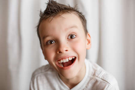 Home portrait of a little boy looking at the camera. Interesting look. Surprise on the face. To be...