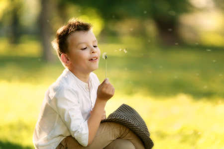 Portrait of happy boy in the hat. Child is smiling in spring day. Kid is enjoying spring. Sunny day....