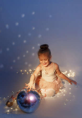 Little dancing girl. Ballerina with disco ball of the circus. Circus illumination.の写真素材