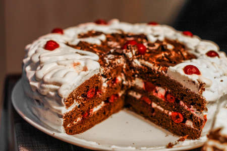 cake with red cherries and white cream toppingの写真素材