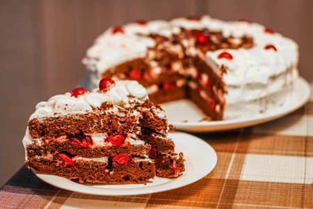 cake with red cherries and white cream toppingの写真素材
