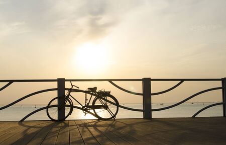 Bicycle at seaside during sunsetの写真素材