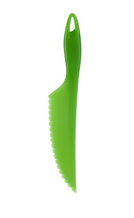 Plastic green knife for vegetable on white backgroundの写真素材