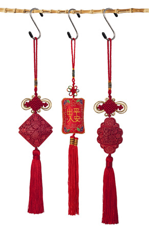 Three traditional chinese pendants hanging on a bamboo stickの写真素材
