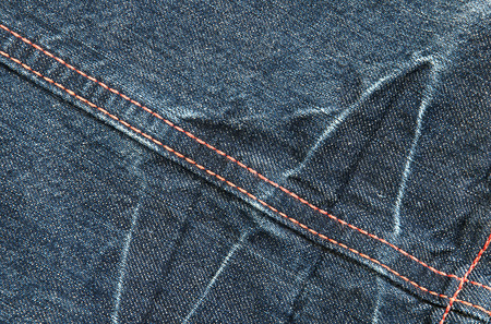 Fragment of blue jeans fabric with colored lineの写真素材