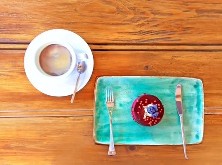 Blueberry cheesecake on plate and cup of coffeeの写真素材
