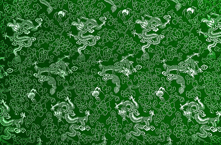 Fragment of green Chinese silk with dragons and flowersの写真素材