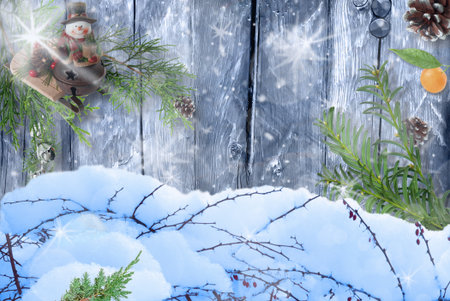 Snow background in front of picture and wooden background with Christmas decor and bokeh effect