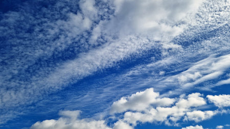 Bright blue sky and white clouds with different structure like background