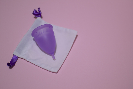 Feminine hygiene during menstruation. Menstrual cycle. Hygiene products for women. Gentle body care. Reusable menstrual cup for long time use. Zero waste life concept. Place for text.の写真素材