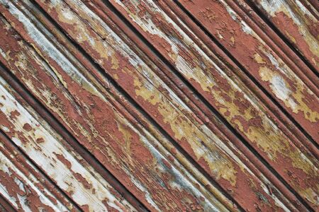 Vintage painted wood background with peeling paint. Wooden texture planks placed obliquely. Layout...