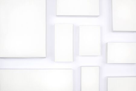 White cardboard boxes on a white background, concept of shopping and delivery. Many boxes of...